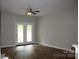 Bright living room with wood floors and access to outdoor patio at 9823 Hyde Glen Ct, Charlotte, NC 28262