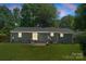 An exterior back view of a home with a backyard and green lawn at 1027 Dresden W Dr, Charlotte, NC 28205