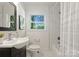 Freshly updated bathroom with natural light, shower-tub combination, and modern fixtures at 1027 Dresden W Dr, Charlotte, NC 28205