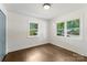 Bright bedroom with hardwood floors and natural light from two windows at 1027 Dresden W Dr, Charlotte, NC 28205