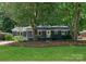 Charming single-story home featuring a freshly painted exterior, landscaped yard, and a welcoming front entrance at 1027 Dresden W Dr, Charlotte, NC 28205