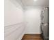 Functional laundry room featuring stacked washer and dryer units and ample storage shelving at 1027 Dresden W Dr, Charlotte, NC 28205