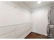 Bright laundry area showcases stacked washer and dryer units with wire shelving for storage at 1027 Dresden W Dr, Charlotte, NC 28205