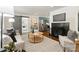 Bright living room features modern furnishings, stylish decor, fireplace with black tile, and access to a cozy dining area at 1027 Dresden W Dr, Charlotte, NC 28205