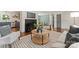 Bright living room features modern furnishings, stylish decor, fireplace with black tile, and access to a cozy dining area at 1027 Dresden W Dr, Charlotte, NC 28205