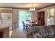 Dining area adjacent to kitchen with chandelier and sliding glass doors at 10414 Tillman Steen Rd, Indian Land, SC 29720