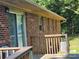 Brick home exterior showing a sliding glass door and a wooden deck at 10414 Tillman Steen Rd, Indian Land, SC 29720