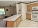 Eat-in kitchen with breakfast bar and matching white appliances at 10414 Tillman Steen Rd, Indian Land, SC 29720