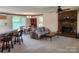Bright living room with brick fireplace, carpet floors, and open layout at 10414 Tillman Steen Rd, Indian Land, SC 29720