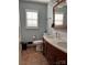 Bathroom featuring a double sink vanity, neutral tile flooring, and a large window at 106 Condover Pl, Charlotte, NC 28270