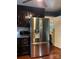 Kitchen showcasing stainless steel appliances, dark cabinets, and hardwood floors at 106 Condover Pl, Charlotte, NC 28270