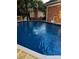 Enjoy the refreshing backyard pool with a brick house surround, creating a private oasis at 106 Condover Pl, Charlotte, NC 28270