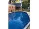 Backyard pool features a new wooden deck, lounge chair, and an outdoor gazebo for entertaining at 106 Condover Pl, Charlotte, NC 28270