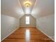 Charming attic bedroom with hardwood floors, natural light, and a unique ceiling design at 11021 Travis Gulch Dr, Charlotte, NC 28277