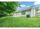 Well-maintained backyard featuring a grassy lawn, partial fence, and light-colored siding on the house at 11021 Travis Gulch Dr, Charlotte, NC 28277