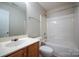 Bathroom boasts a single sink vanity and combination tub and shower with white tile at 11021 Travis Gulch Dr, Charlotte, NC 28277