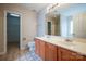 Bathroom featuring double sink vanity, tile floor, toilet, and walk-in closet for ample storage at 11021 Travis Gulch Dr, Charlotte, NC 28277