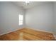 Bedroom featuring hardwood flooring, a neutral wall color, and a single window at 11021 Travis Gulch Dr, Charlotte, NC 28277