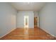 Spacious bedroom with hardwood floors, an open doorway, and neutral decor at 11021 Travis Gulch Dr, Charlotte, NC 28277