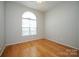 Bedroom featuring hardwood flooring, arched window, and ceiling fan at 11021 Travis Gulch Dr, Charlotte, NC 28277