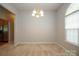 Dining room with neutral carpet and chandelier; kitchen and arched window visible at 11021 Travis Gulch Dr, Charlotte, NC 28277