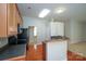 Well-equipped kitchen with wooden cabinets, modern appliances, laminate countertops and a breakfast bar for casual dining at 11021 Travis Gulch Dr, Charlotte, NC 28277
