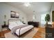 Bright main bedroom showcasing hardwood floors, a modern bed frame, and tasteful decor at 11021 Travis Gulch Dr, Charlotte, NC 28277