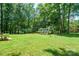 Lush backyard with mature trees and a small outbuilding or shed at 116 April Ln, Dallas, NC 28034