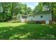 Well-maintained home featuring a rear deck and lush green lawn at 116 April Ln, Dallas, NC 28034