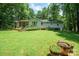 Back exterior of home showcasing a cozy porch and well-kept yard at 116 April Ln, Dallas, NC 28034