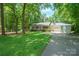Inviting single-story home with a lovely front yard, attached garage, a classic design, and a cozy front porch at 116 April Ln, Dallas, NC 28034