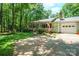Charming single-story home with a covered front porch, attached garage, and a beautifully landscaped front yard at 116 April Ln, Dallas, NC 28034