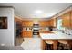 Well-lit kitchen with stainless steel appliances, oak cabinets, white countertops, and tile flooring at 116 April Ln, Dallas, NC 28034