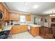 Functional kitchen with wood cabinets, white countertops, and tile flooring leading to the dining room at 116 April Ln, Dallas, NC 28034