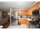 Charming kitchen featuring updated stainless steel appliances and oak cabinets with white countertops at 116 April Ln, Dallas, NC 28034