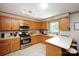 Well-lit kitchen with stainless steel appliances, ample cabinet space, and tiled flooring at 116 April Ln, Dallas, NC 28034