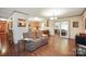 An open living room with hardwood floors, plush sofas, and an adjacent kitchen and dining area at 116 April Ln, Dallas, NC 28034