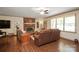 A cozy living room featuring hardwood floors, brick fireplace, and comfortable seating at 116 April Ln, Dallas, NC 28034