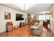 A cozy living room featuring hardwood floors, brick fireplace, and comfortable seating at 116 April Ln, Dallas, NC 28034