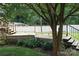 Backyard featuring a multi-tiered wooden deck with stairs, surrounded by lush greenery and mature trees at 116 Woodbark Ln, Kings Mountain, NC 28086