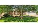 Inviting single-story brick home with a cozy porch and charming curb appeal, surrounded by mature trees and lush landscaping at 116 Woodbark Ln, Kings Mountain, NC 28086