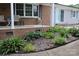 Inviting front porch with a chair, lush landscaping, and a well-maintained lawn at 116 Woodbark Ln, Kings Mountain, NC 28086