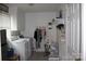 Functional laundry room equipped with a washer, dryer, and ample shelving for storage at 116 Woodbark Ln, Kings Mountain, NC 28086