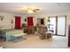 Spacious living area featuring a ceiling fan, comfortable seating, and sliding doors leading to the outdoors at 116 Woodbark Ln, Kings Mountain, NC 28086