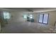 Bright living room with multiple windows, ceiling fan and door to the outside at 116 Woodbark Ln, Kings Mountain, NC 28086