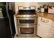 Stainless steel double oven with black stove top in a white cabinet kitchen at 116 Woodbark Ln, Kings Mountain, NC 28086