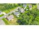 Aerial view of backyard and neighborhood homes with green lawns and mature trees at 11618 Macallano Dr, Charlotte, NC 28215