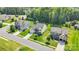Aerial view of neighborhood homes with mature trees and manicured lawns at 11618 Macallano Dr, Charlotte, NC 28215