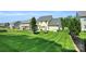 Well-maintained backyard showcasing lush lawn, and a black metal fence, ideal for recreation and relaxation at 11618 Macallano Dr, Charlotte, NC 28215