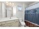 Bright bathroom featuring a single sink vanity and a shower with a decorative curtain at 11618 Macallano Dr, Charlotte, NC 28215